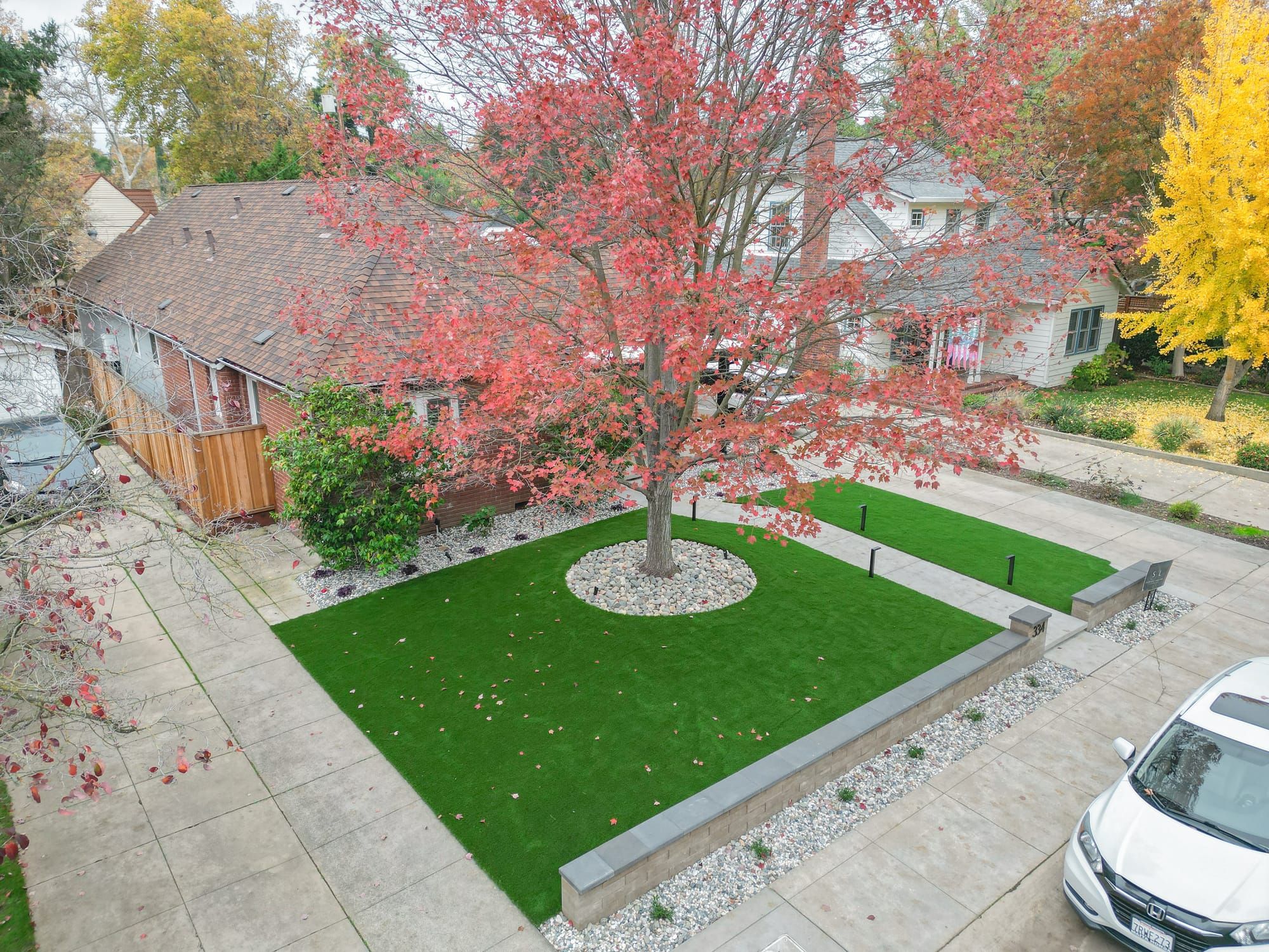 Aerial view of Sacramento front yard with artificial turf and fall foliage