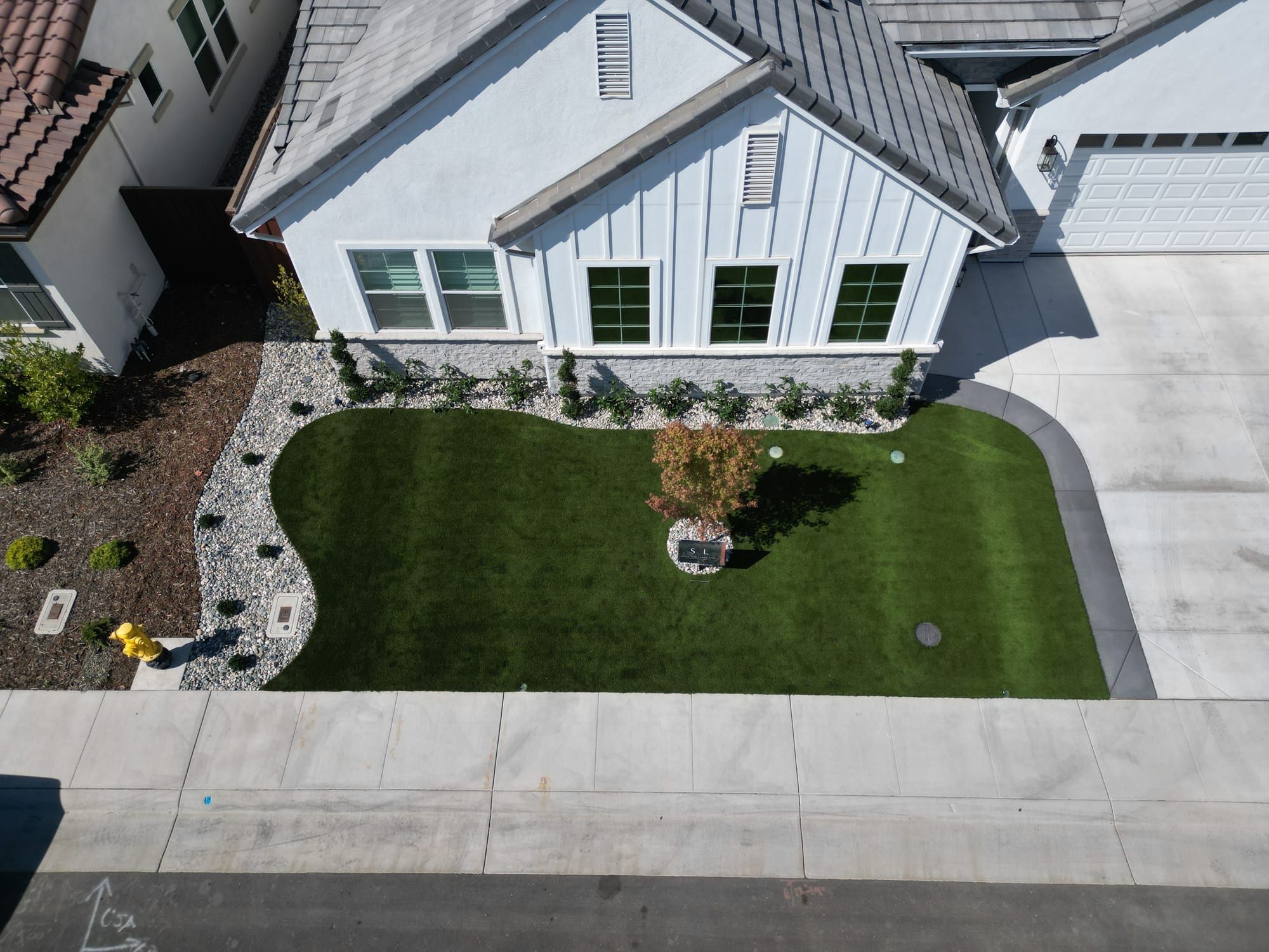 Aerial view of Sacramento front yard with artificial turf and Stuteville Landscaping sign