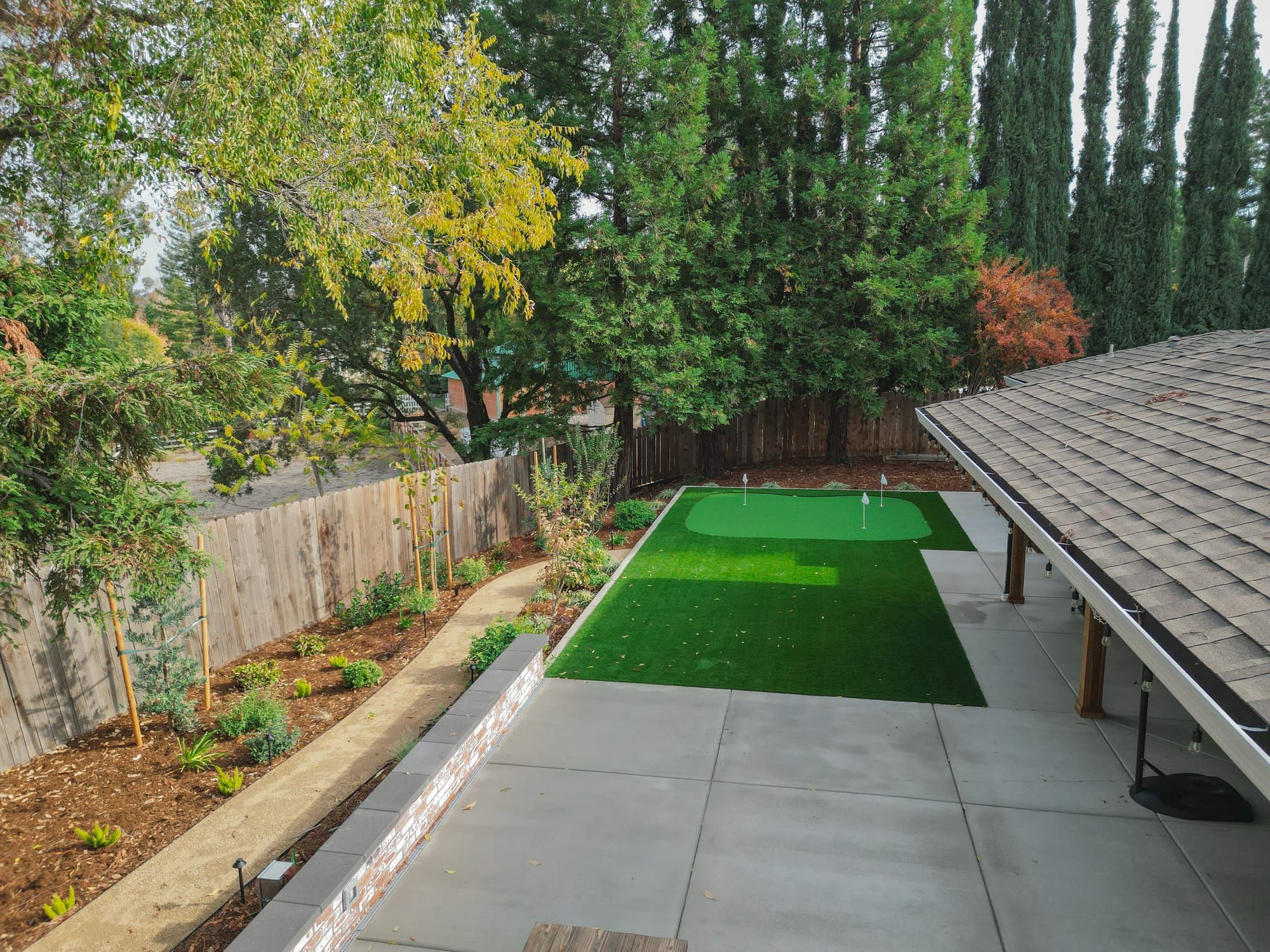 Sacramento backyard putting green with paver patio and landscaping